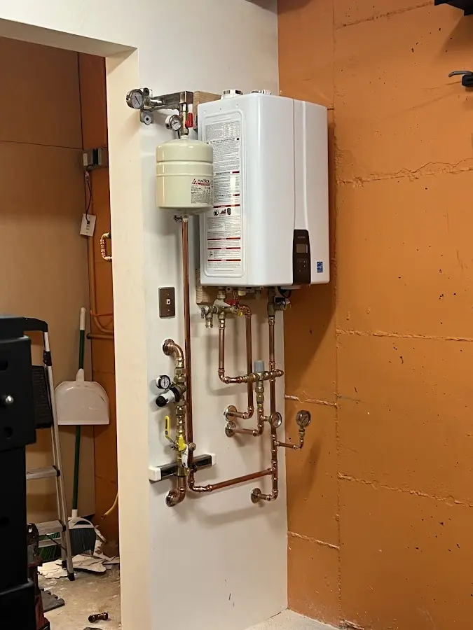 Plumbing technician inspecting water heater connections in Hyattsville